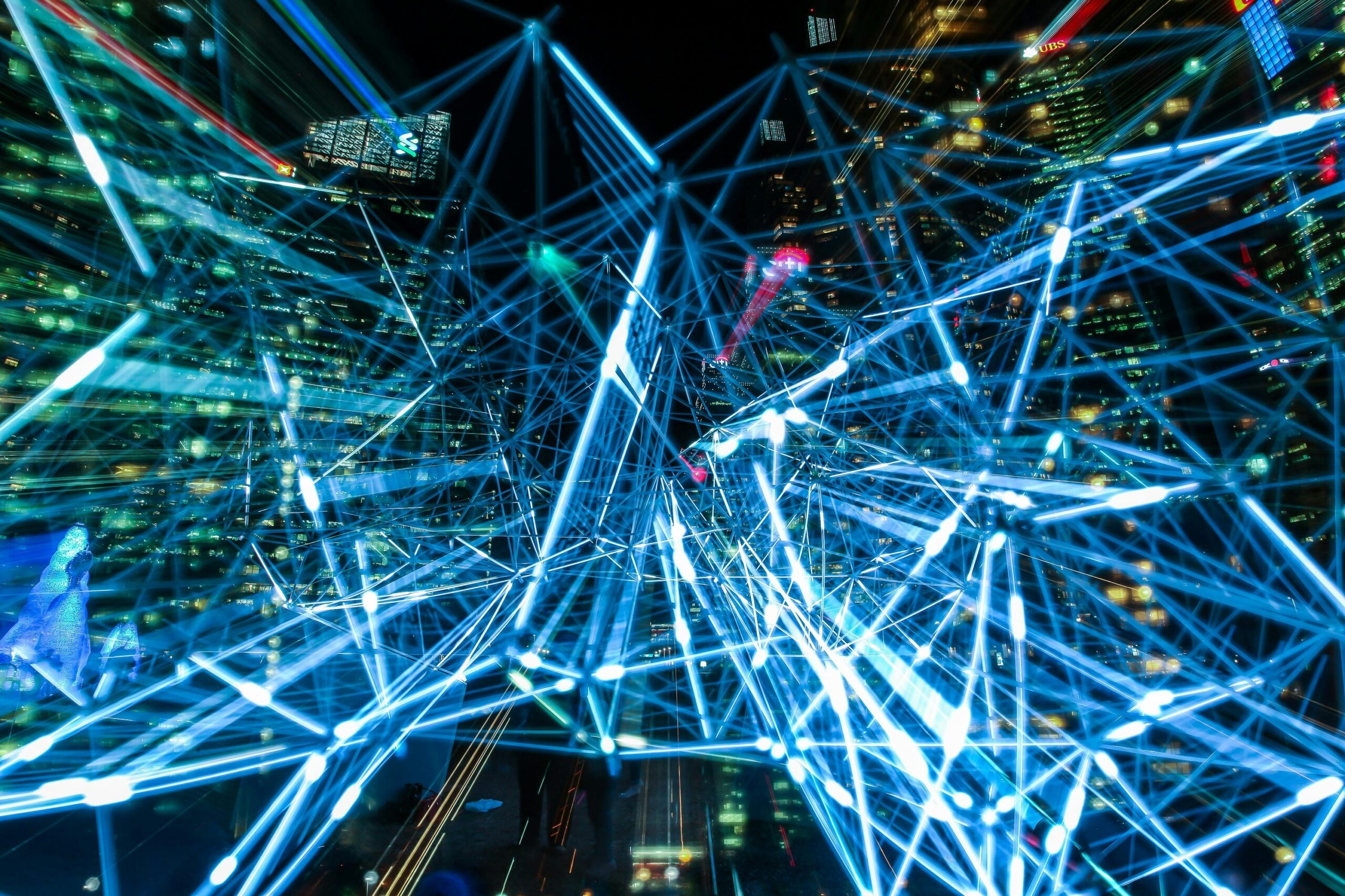 Dynamic urban scene showcasing interconnected light trails representing digital communication networks. In this context it is used to resemble the use of AI-generated websites compared to hiring a professional web designer.